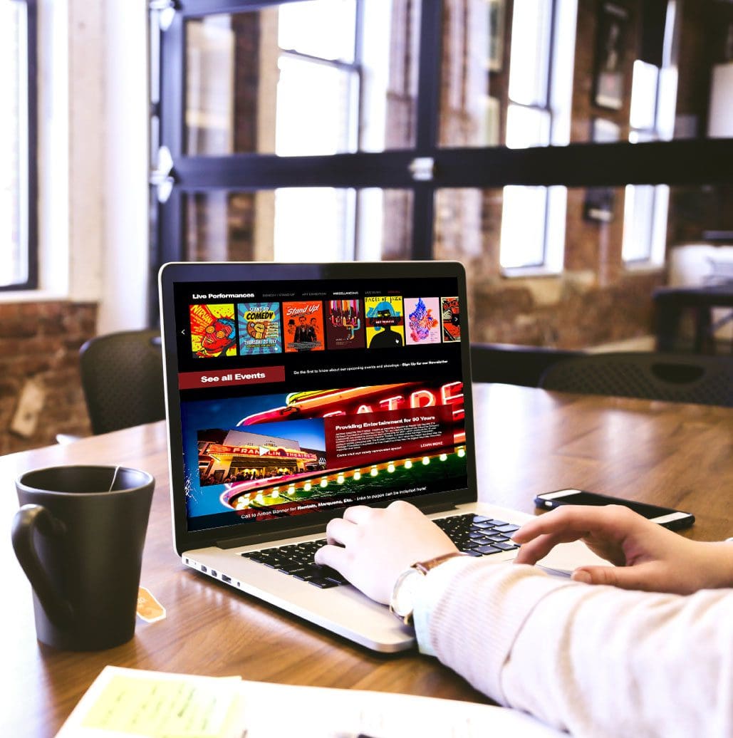 person at a coffee shop scrolling through a stunning website design from a company in spring hill tn near brentwood